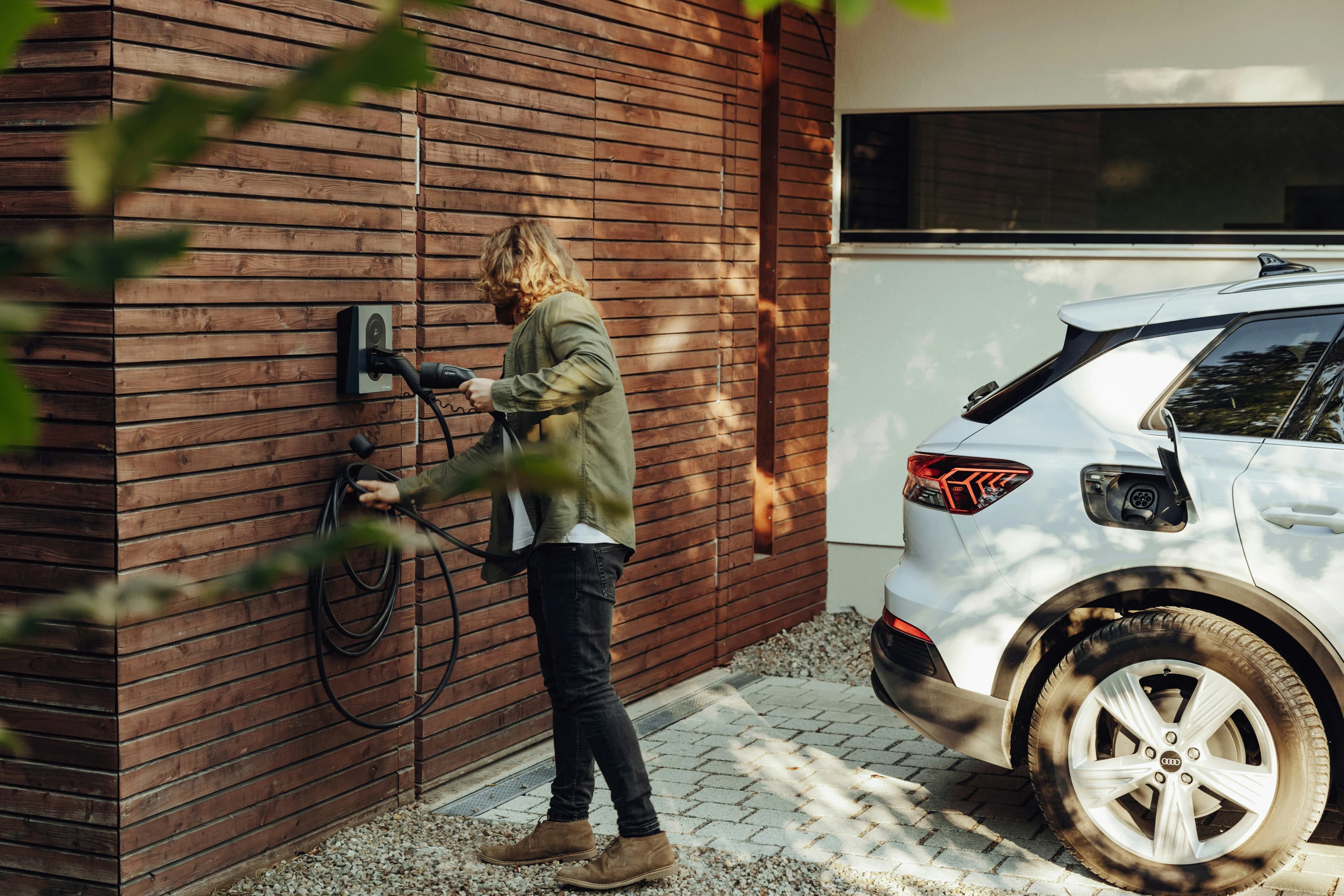 Electric vehicle charging at a modern home with integrated wall charger