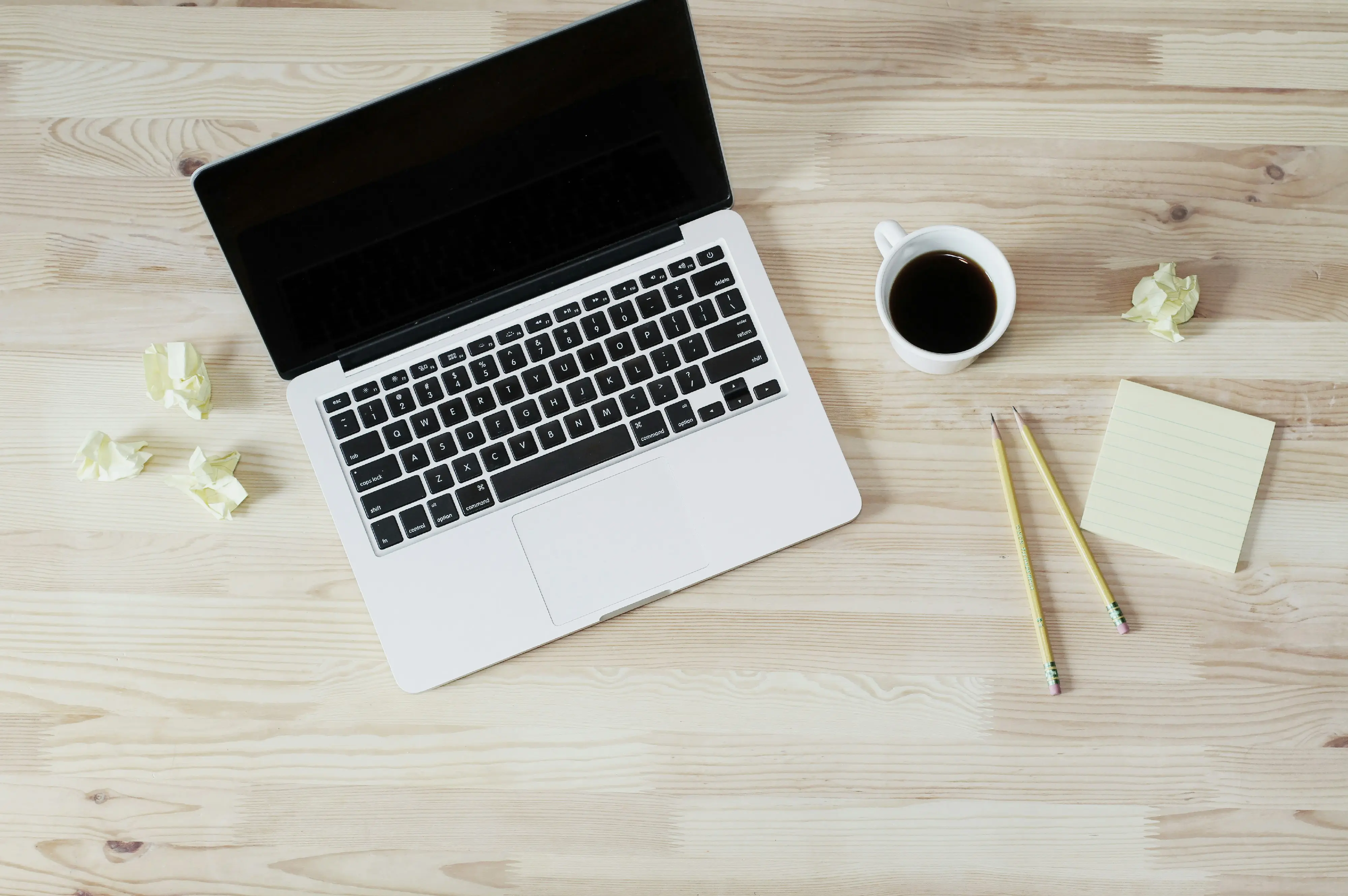 Laptop, coffee, and pencil on a desk — calm focus at work